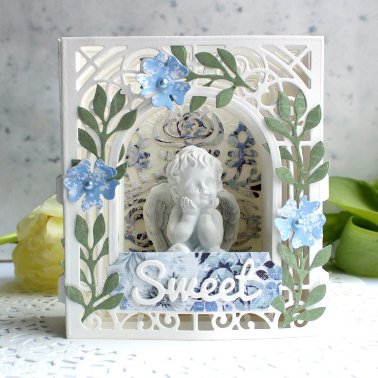 Video Friday | Paper Diorama / Figurine Holder with Olga using S3-303 Little Plants, S4-563 Phrase Set One, S4-883 Nordic Tree, S5-338 Wreath Elements, S6-138 Grand Arch 3D Card, SES-013 Flourish Stitch #spellbinders #diecutting 