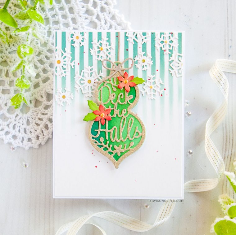 Spellbinders Die D-Lites Holiday 2019 Inspiration | Clean & Simple Christmas Cards with Keeway Tsao. Keeway says: "This card showcases the Die D-Lites Deck The Halls dies. I die cut the ornament twice, one out of white card stock and the second one out of gold glitter card stock. The second one also was die cut again to cut out the words ‘deck the halls’ leaving you with an intricate frame."