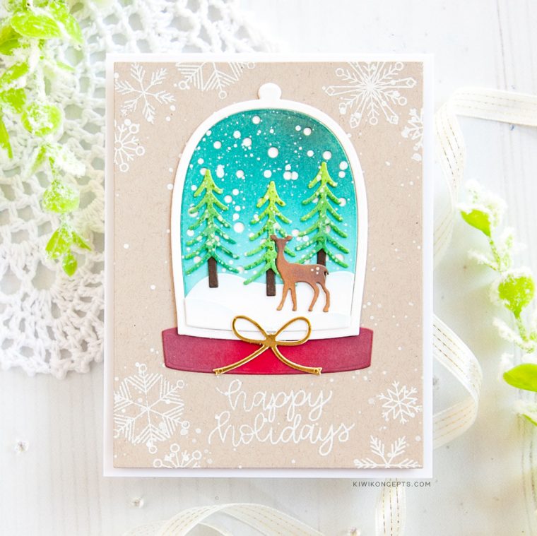 Spellbinders Holiday 2019 Inspiration | Clean & Simple Christmas Cards with Keeway Tsao. Keeway says: "This card showcases the Shapeabilities Santa’s Workshop dies. This die creates a beautiful little scene within a snow globe. I started by die cutting the snow globe frame and backing which was then ink blended with Peacock Feathers and Tumbled Glass distress oxide inks."